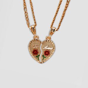 Two gold-tone necklaces featuring matching pendant halves of a broken heart. Each half is engraved with "Te Amo" and adorned with red roses, forming a complete heart when placed together.